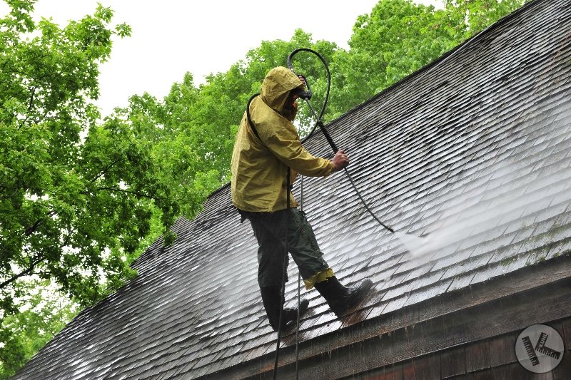 Man Washing a Cedar Roof in Minnesota by Kuhl's Contracting